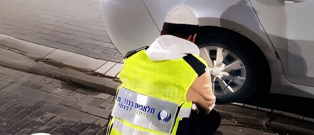 מתנדב מסייע בהחלפת גלגל בשטח
